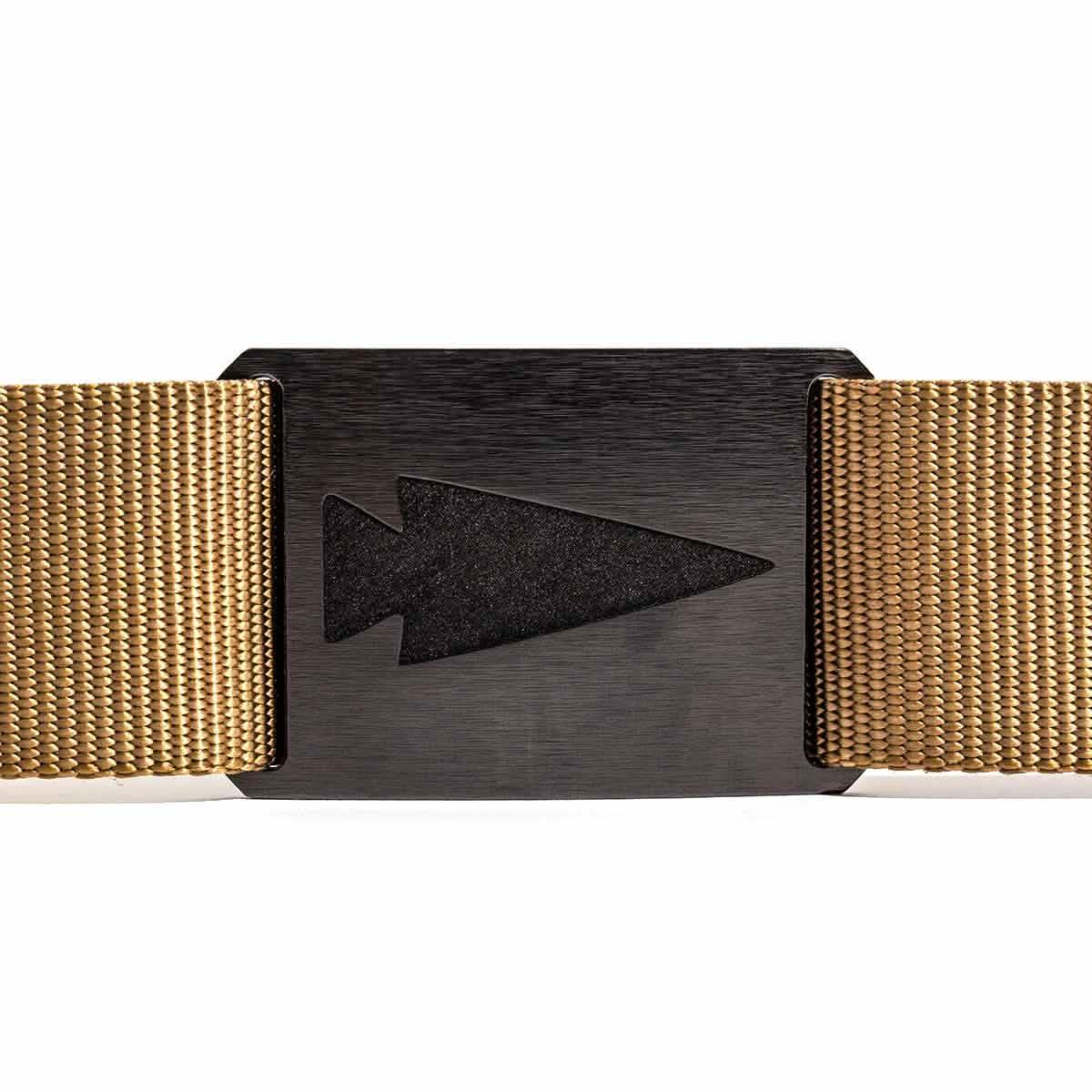Close-up of a black metal arrowhead belt buckle on a tan woven tactical belt