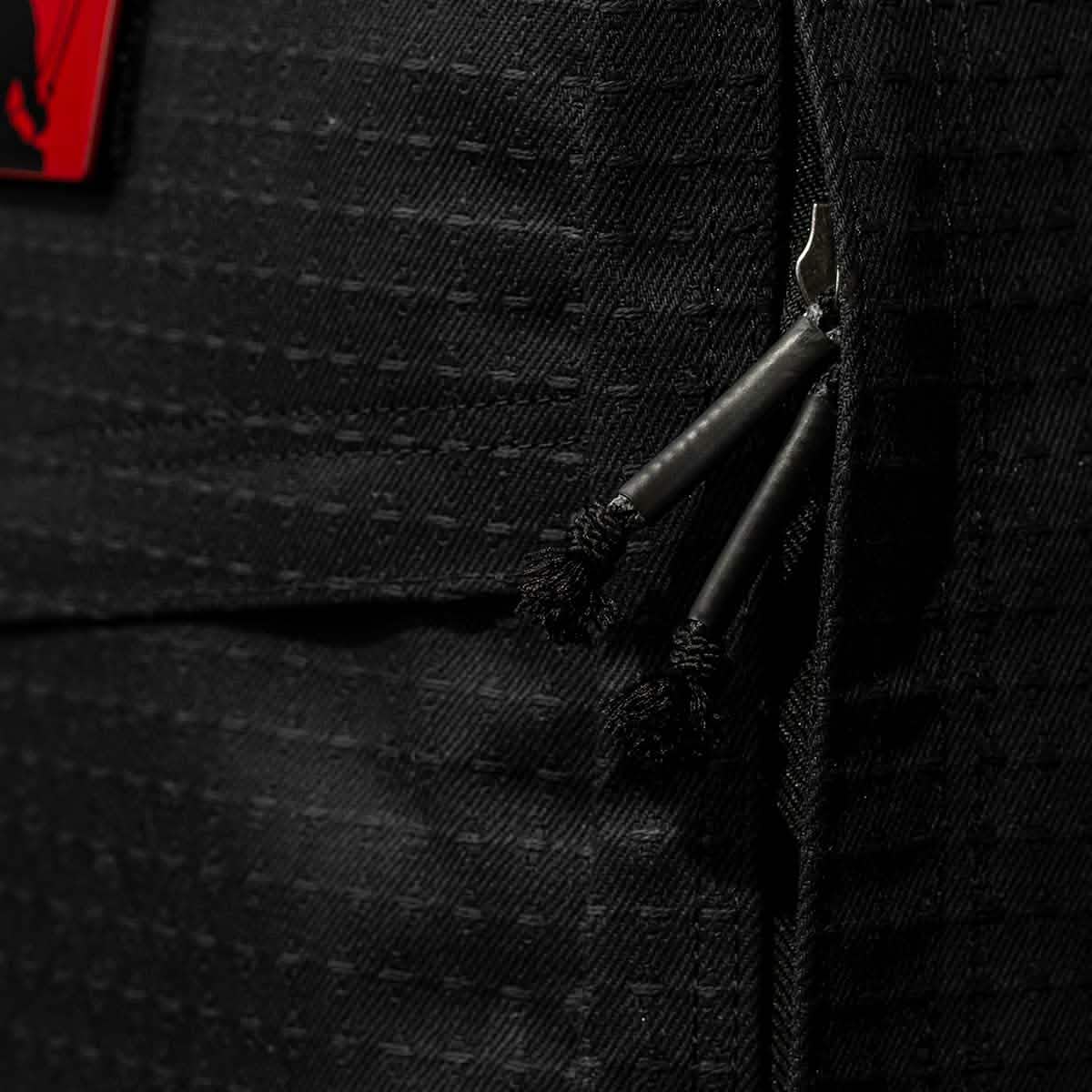 Close-up of black zippers on a textured Japanese cotton fabric bag with a red patch, part of the GR1 USA x Carryology - GRXC2 Samurai collaboration.