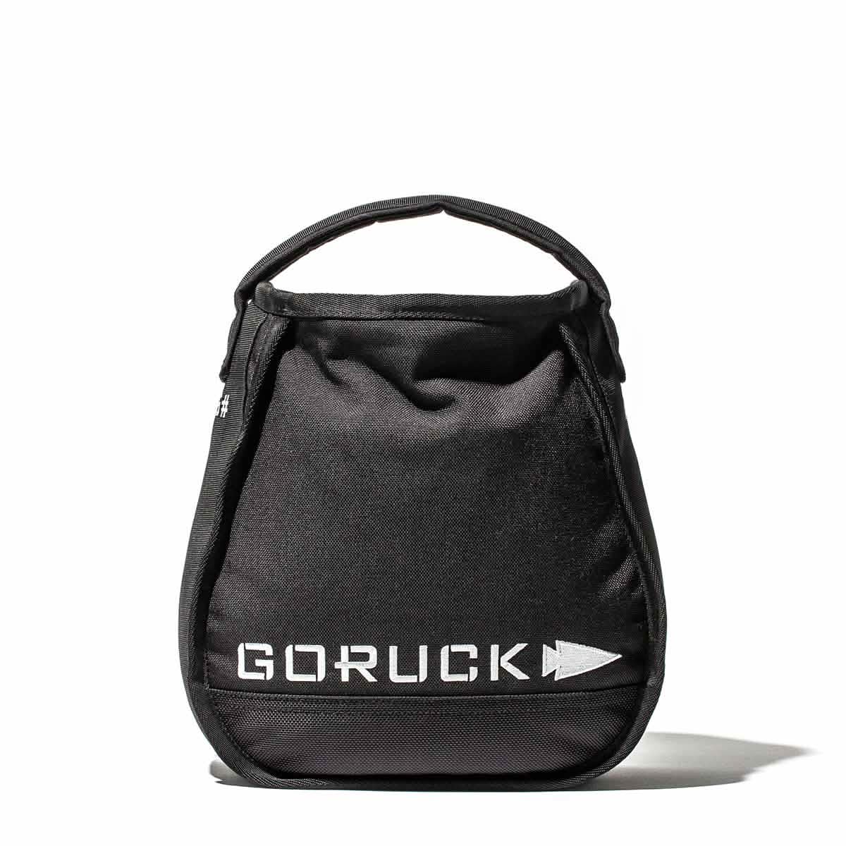 The black GORUCK Sand Kettlebells gym bag, featuring the brand's logo in white letters on the front, seamlessly integrates an enduring design. Set against a plain white background, it's perfect for transporting kettlebell essentials.