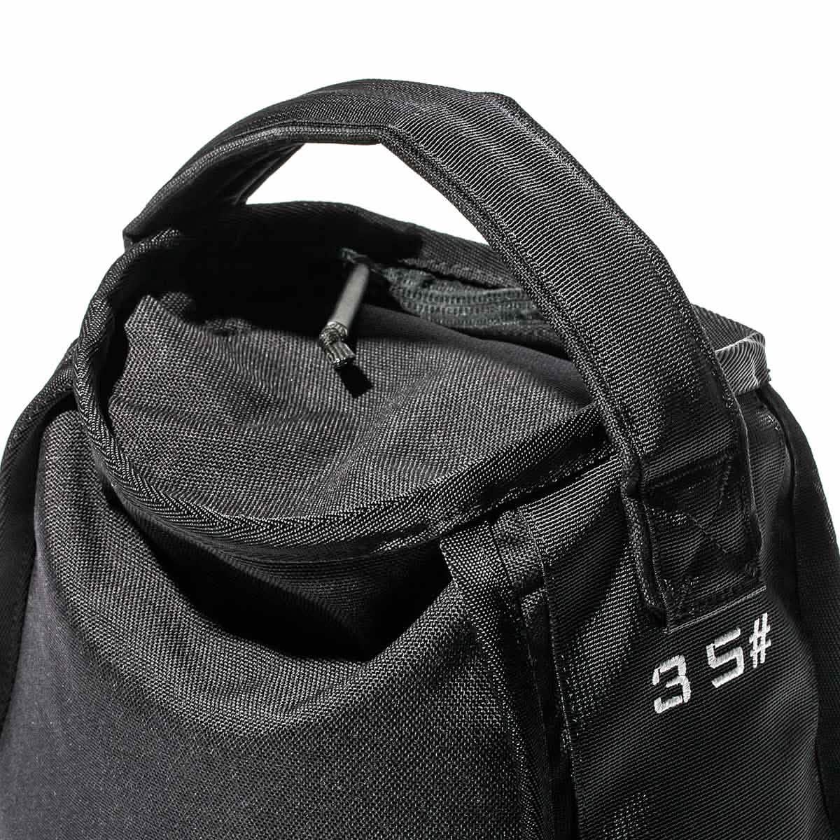 Close-up of black GORUCK 35-pound ruck weight bag with sturdy handle and zipper detail