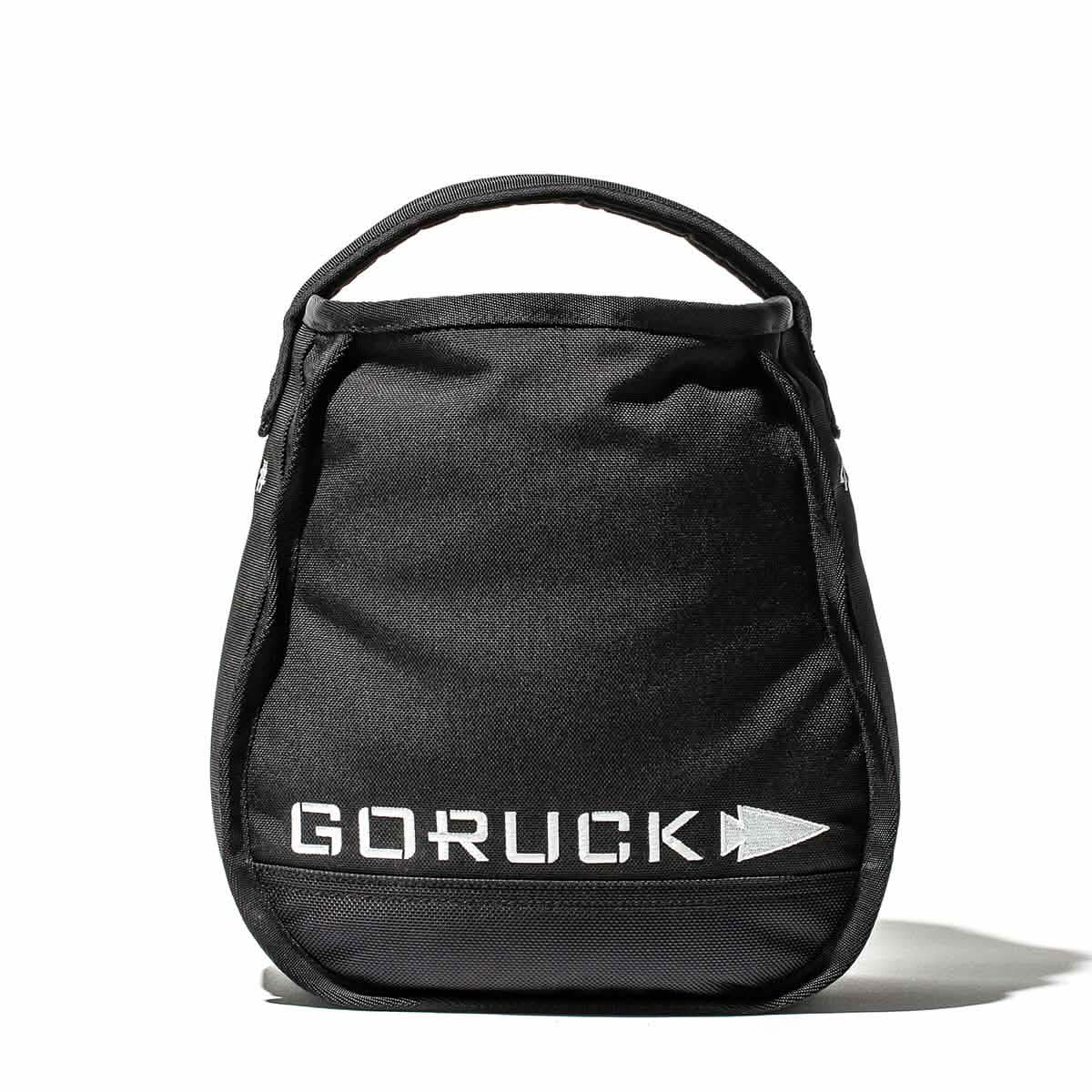A GORUCK Sand Kettlebell in black, featuring handles on top and reflective lettering on the front, set against a white background, showcases an endurance design.