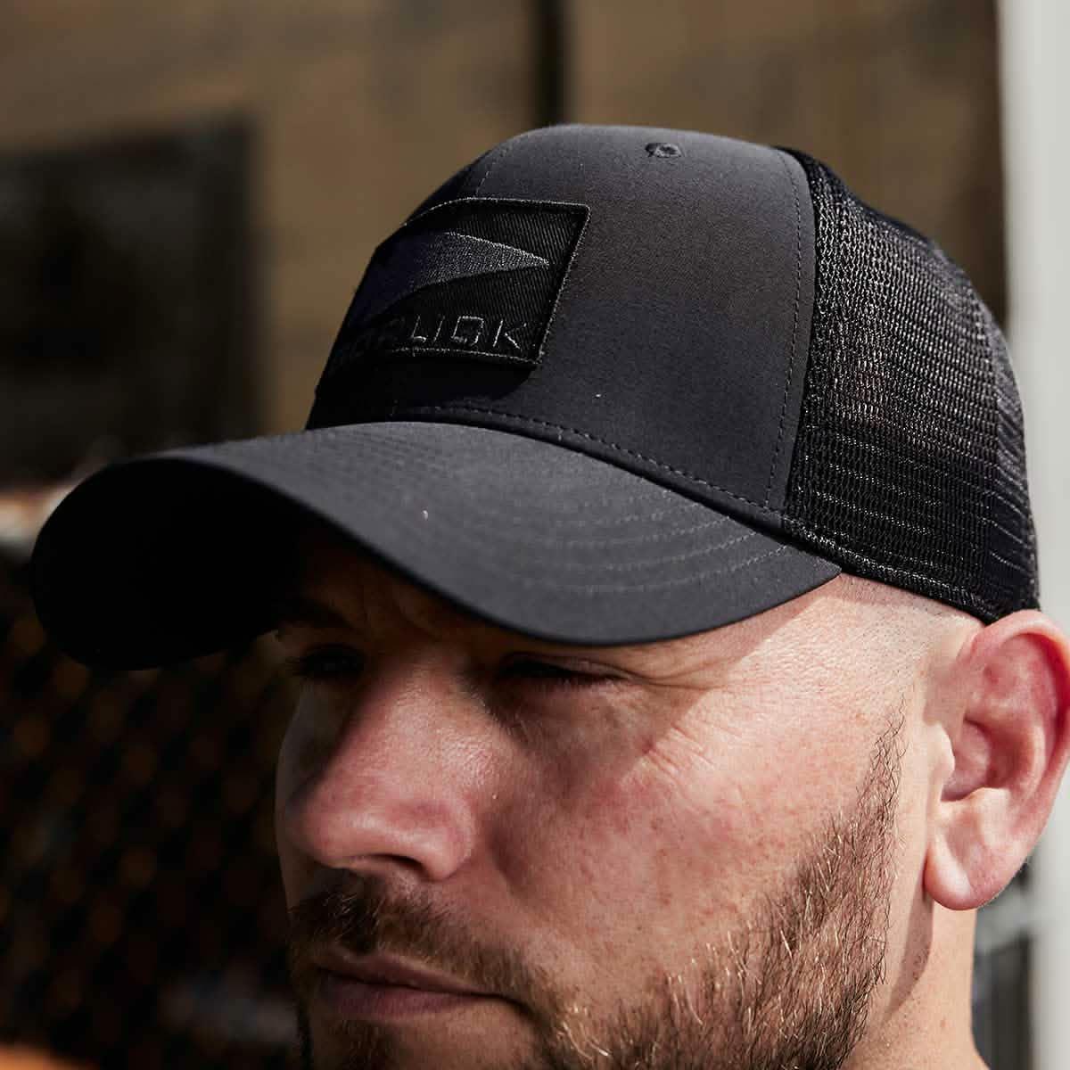 GORUCK black trucker hat with spearhead patch on man outdoors