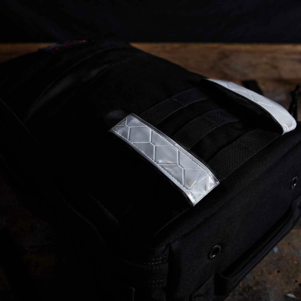 GORUCK rucking backpack with white reflective bands on MOLLE webbing