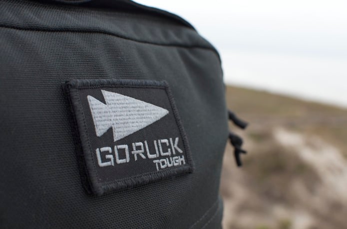 GORUCK Tough patch on black rucksack outdoors, rugged rucking gear close-up