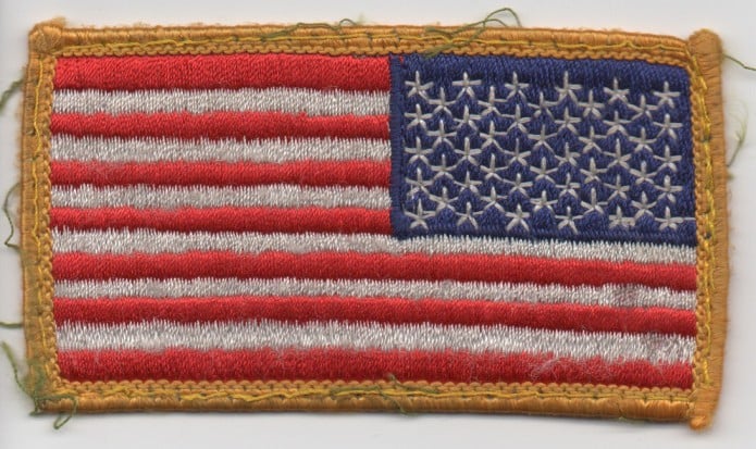 Reversed vintage embroidered American flag patch with 48 stars and red and white stripes bordered in yellow