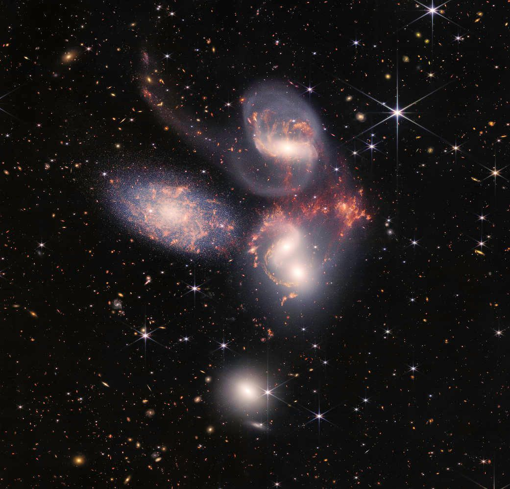 James Webb Space Telescope image of Stephan's Quintet galaxy cluster with vibrant swirling galaxies and distant stars