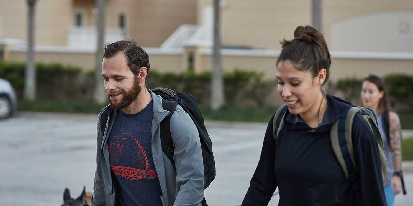Man and woman wearing GORUCK backpacks rucking outdoors together