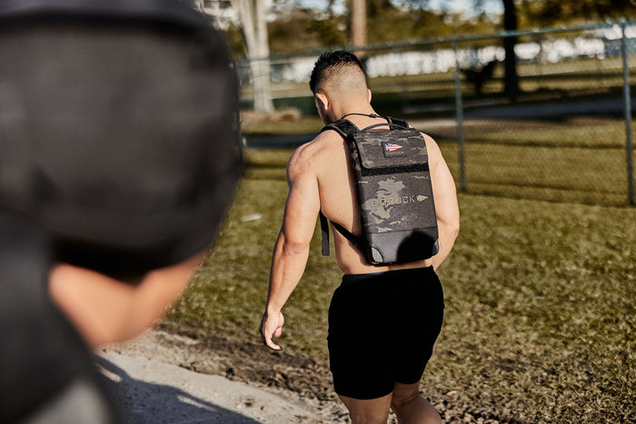 Man outdoors wearing GORUCK rucksack, showcasing tough rucking gear and active lifestyle