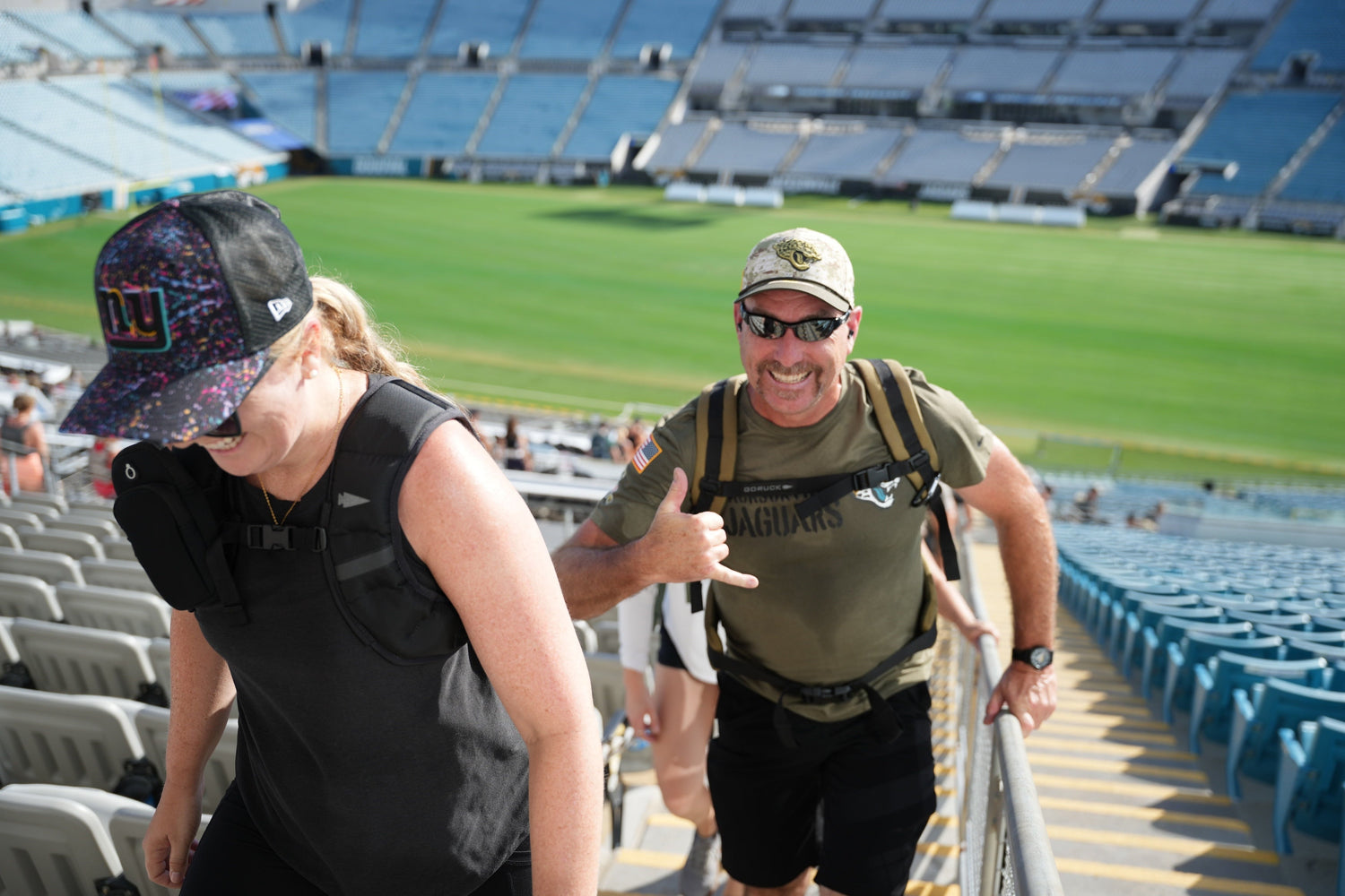 GORUCK event participants rucking upstairs in a stadium, wearing backpacks and athletic gear
