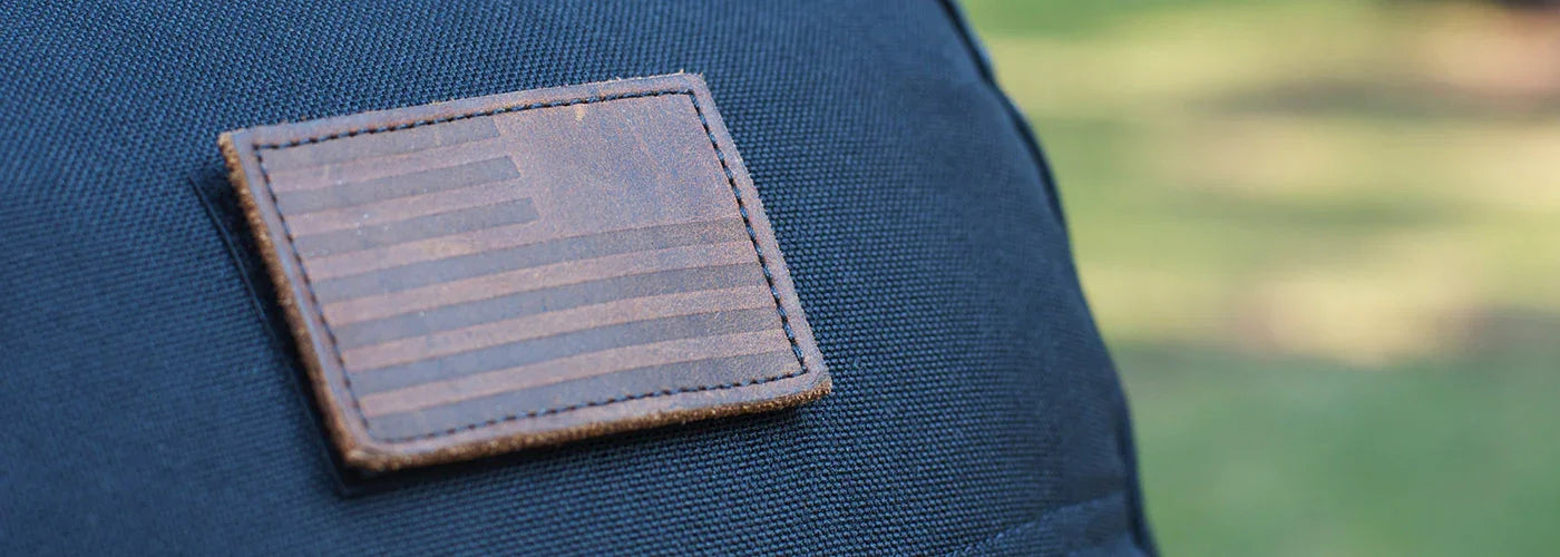 Close-up of GORUCK gear featuring a leather patch with an American flag design on black rugged fabric