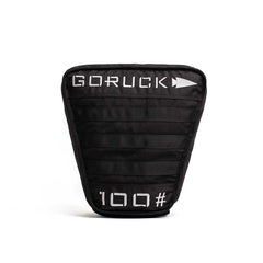 Black GORUCK 100lb weighted rucking plate with white logo and number on front