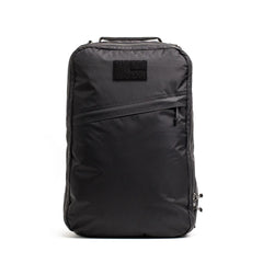 Black GORUCK rucksack with diagonal front zipper and top handle on white background