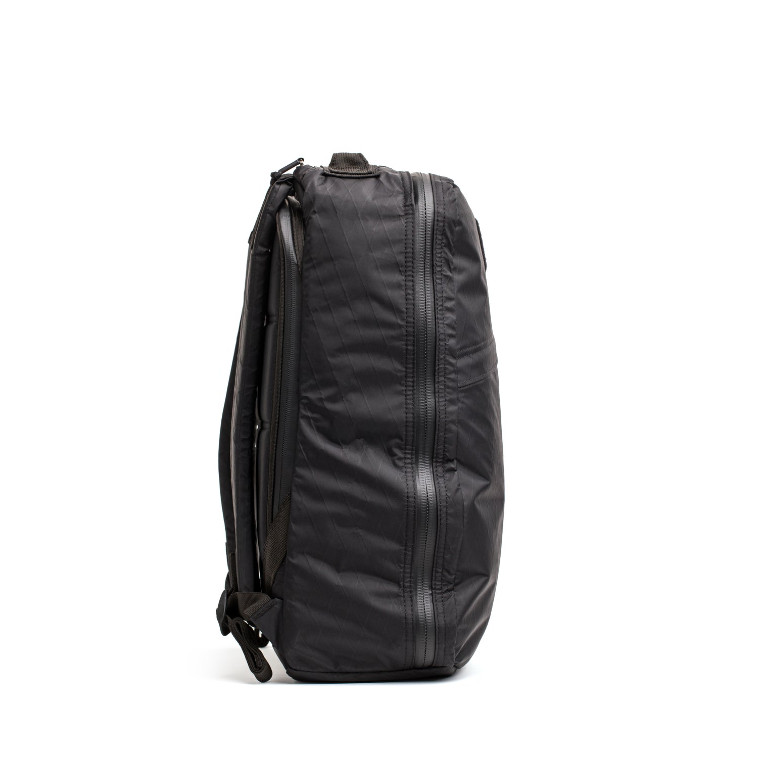 The GR1 USA - Waterproof X-PAC rucksack in black stands upright, shown from the side against a white background, showcasing its rugged, durable gear design.