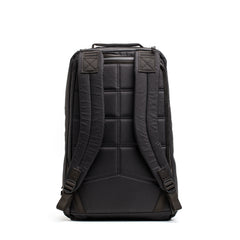 The GR1 USA - Waterproof X-PAC backpack in black is shown from the back, highlighting its padded shoulder straps, quilted design, and rugged waterproof construction.