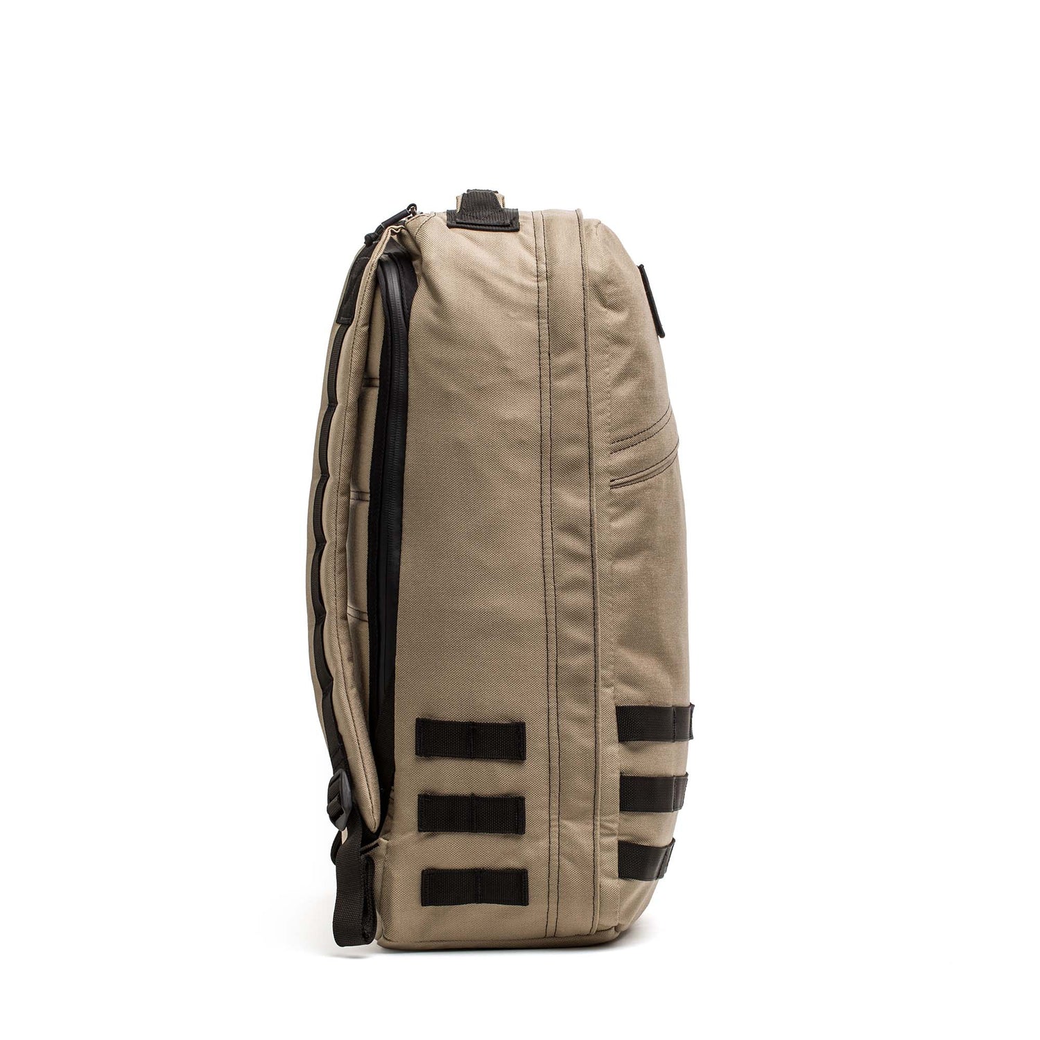 Side view of the tan GR1 USA - Cordura backpack with black straps and zippers, standing upright against a white background. This everyday carry rucksack is built for durability and daily use.