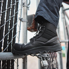 GORUCK black tactical boot on foot stepping on metal fence outdoors