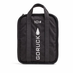A rugged-textured Rucker bag in black from GORUCK, featuring two handles and adorned with "GORUCK" and "10" printed in white alongside an arrow design. The front showcases vertical stitching lines, and it comes with a lifetime guarantee for ultimate peace of mind.