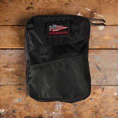 GORUCK black rucking gear pouch with mesh pocket on rustic wooden surface