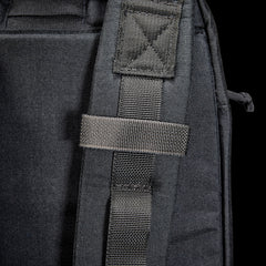 Close-up of the Bullet Ruck USA Throwback's black strap featuring CORDURA construction and a stitched loop, set against a dark background.