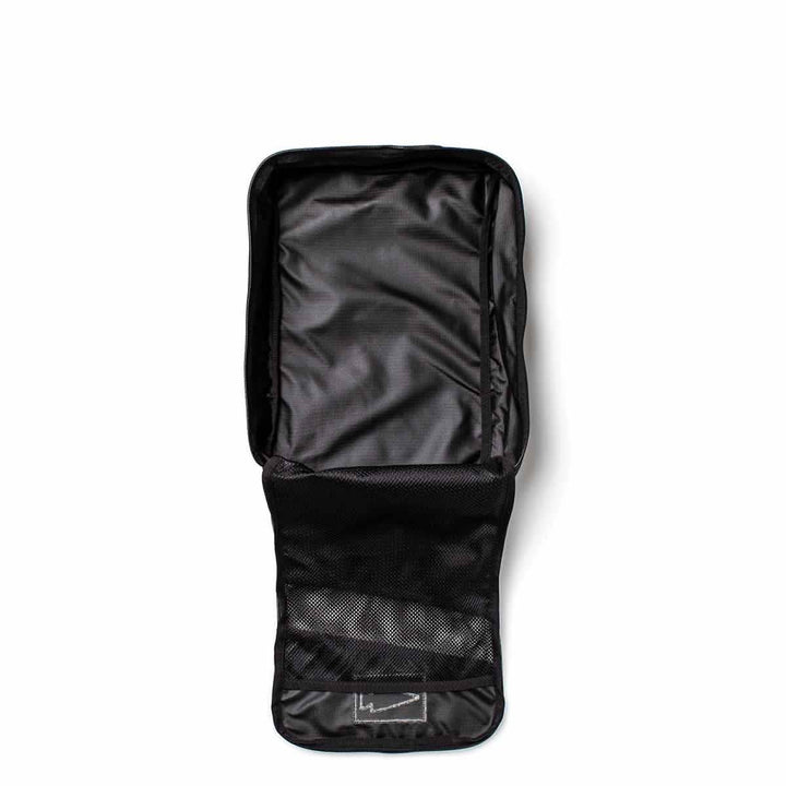 Introducing the Black Shoe Bag - Ripstop ROBIC® by GORUCK, featuring multiple compartments, including mesh pockets. This water-resistant bag is expertly designed for organizing personal items and comes with a lifetime guarantee. It is displayed on a white background, highlighting its practical interior design.