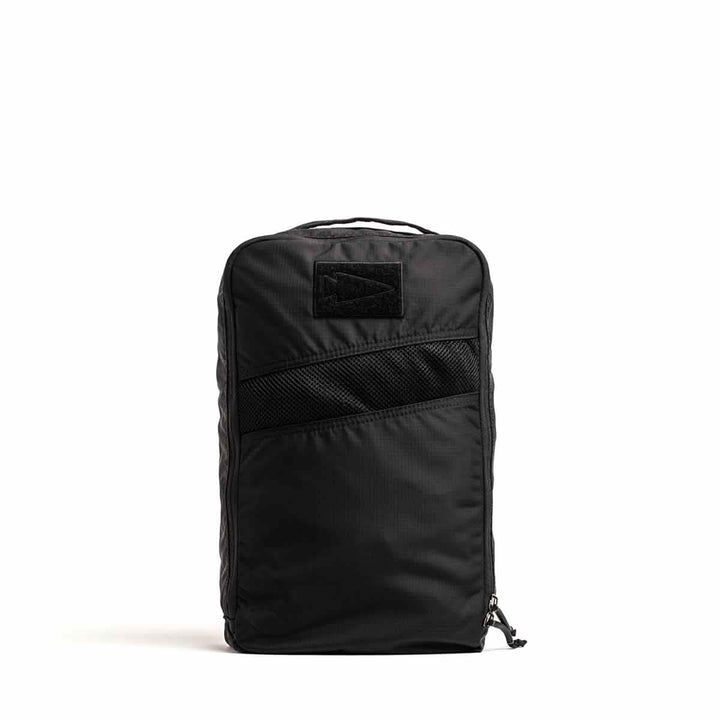 A sleek black, rectangular Shoe Bag - Ripstop ROBIC® by GORUCK is shown against a plain white background. The backpack features multiple zippered compartments, a top handle, water-resistant fabric, a functional shoe bag pocket on the front, and a subtle logo on the top panel.