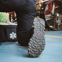 GORUCK tactical boot sole close-up in action on blue floor, emergency gear visible