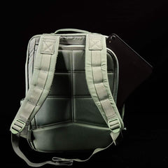 GORUCK tactical green rucksack with padded straps and a black tablet partially inserted