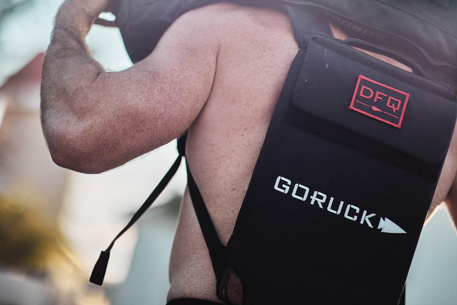 A shirtless person wears a black RPC Long + 30LB (Long) Plate Bundle with a 
