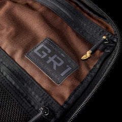 Close-up of the GR1 interior, highlighting its patch, rugged zippers, and mesh pocket—an American-made backpack built to Special Forces standards.