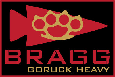 Red arrowhead with gold brass knuckles and bold "BRAGG" and "BRAGG EVENT WEEKEND 2026" text below—a tribute inspired by GORUCK Heavy and Special Forces training.