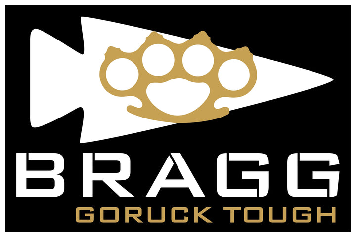 White arrowhead with golden brass knuckles and "BRAGG GORUCK TOUGH" in bold on black—celebrating BRAGG EVENT WEEKEND 2026 and its Special Forces training roots.