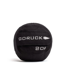 The Sand Medicine Ball in black, adorned with the GORUCK logo and a 20# weight marking, is ideal for boosting core stability. Tailored for fitness training in your home gym, it boasts reinforced stitching and a rugged texture, with the ball displayed against a white background.