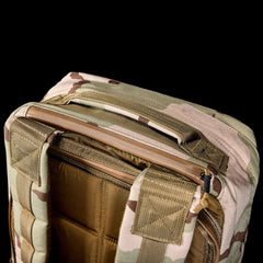 Close-up of the GR1 USA - Ballistic Nylon Cordura (The Original Ruck) 210D Back Panel, highlighting the top handle, zipper, and shoulder straps against a black background.