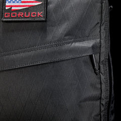 Close-up of black GORUCK rucksack with USA flag patch and rugged ripstop fabric