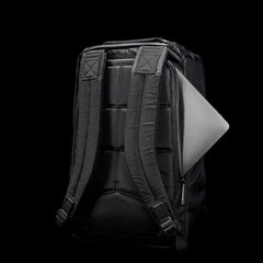 GORUCK black rugged backpack with padded straps and laptop partially visible in side compartment