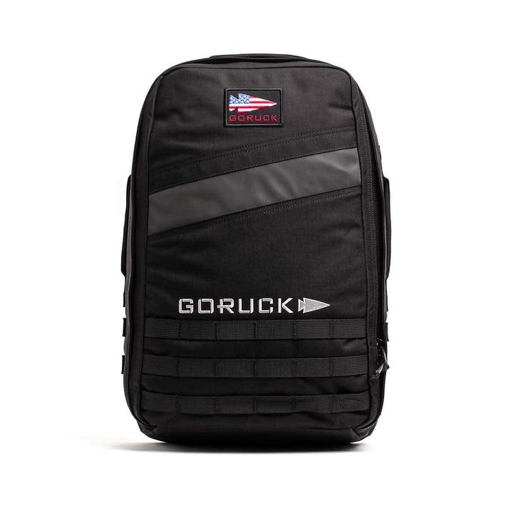 Black GORUCK Rucker 4.0 with logo, front zippered pocket, and horizontal reflective strip—ideal for rucking or carrying Ruck Plates—shown on a white background.