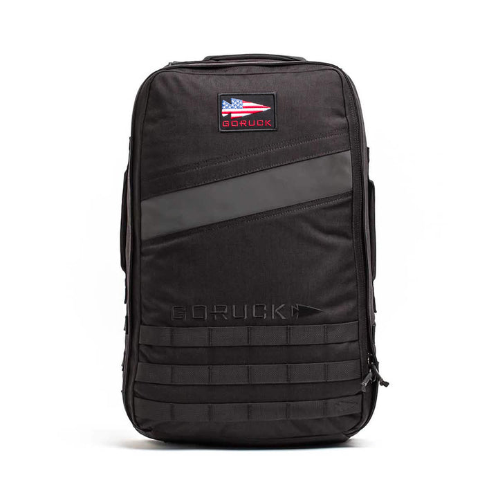 The black Rucker 4.0 features an American flag patch and a red GORUCK logo on the front—ideal for rucking or carrying Ruck Plates.