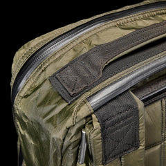 Close-up of rugged dark green GORUCK rucking bag corner with heavy-duty handle and weather-resistant zipper