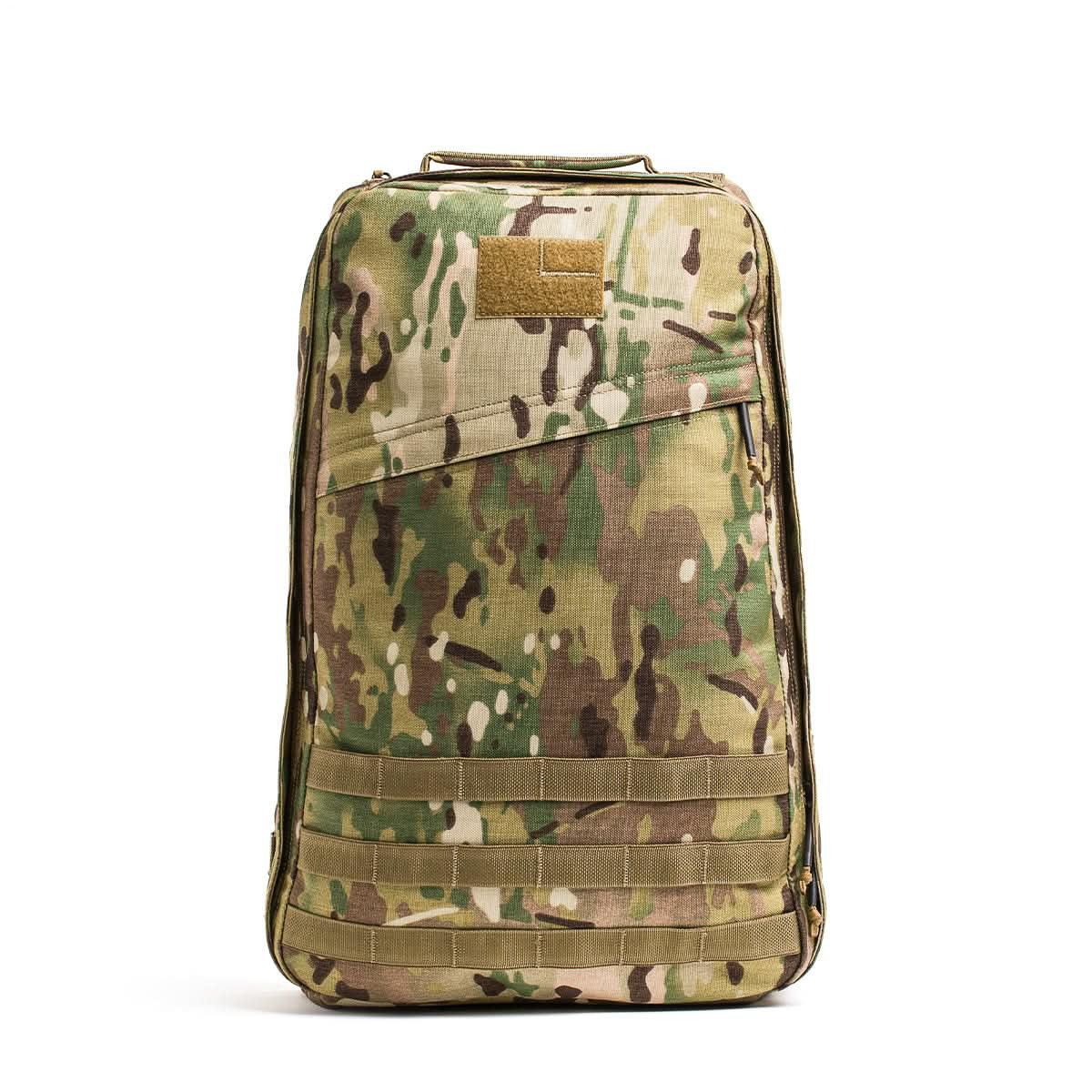 A GR1 rucksack with a camouflage pattern, featuring a top handle and a front zippered compartment, shown standing upright.