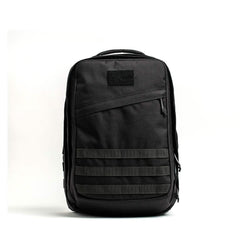 The GR2 - Cordura by GORUCK is a sleek, black tactical backpack with a minimalist design. It features a top handle, multiple compartments, and horizontal strap detailing on the front, inspired by Special Forces ruck gear. The backpack stands upright against a plain white background.