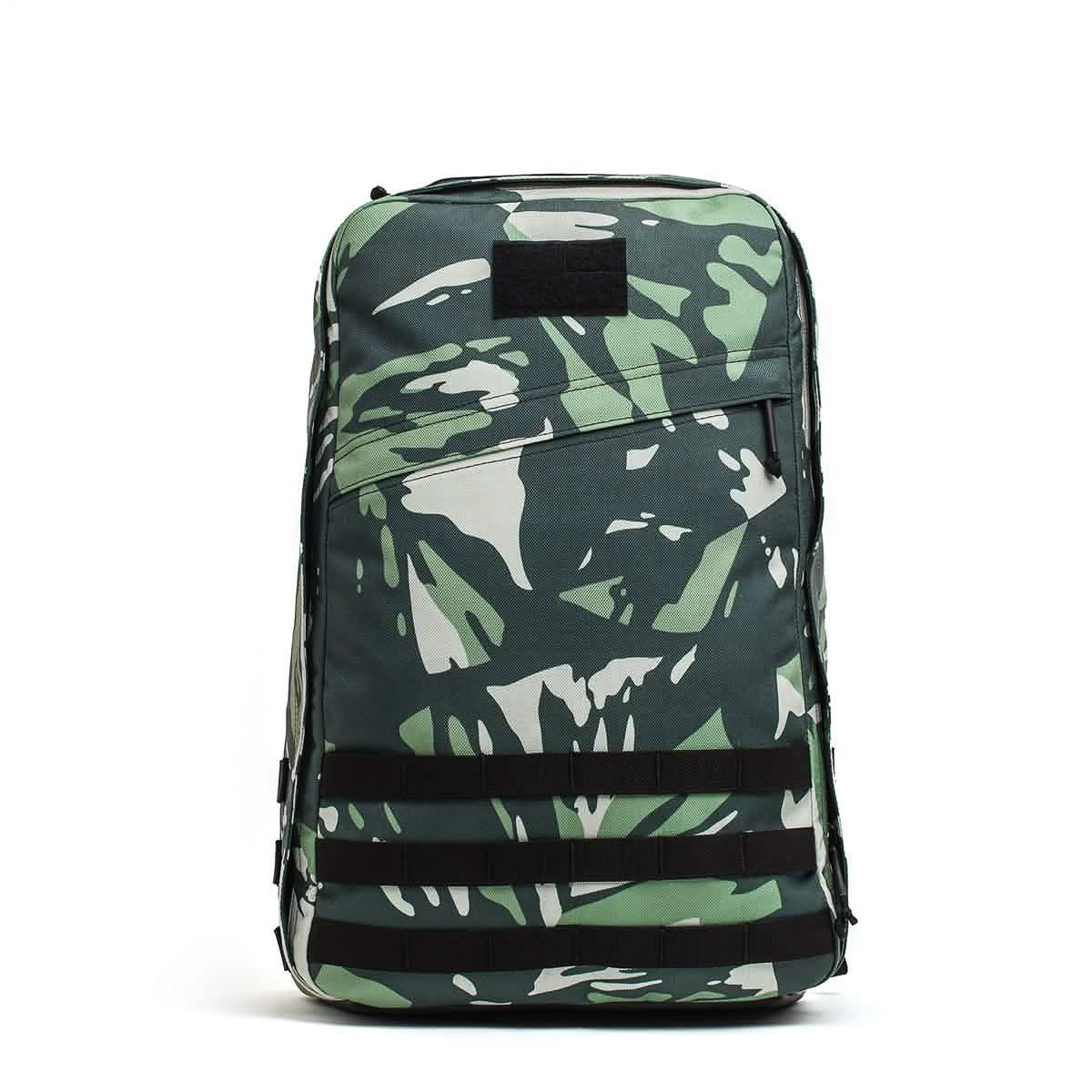 The GR1 rucksack features green and white camouflage, black straps, and a front zipper pocket, shown on a white background.