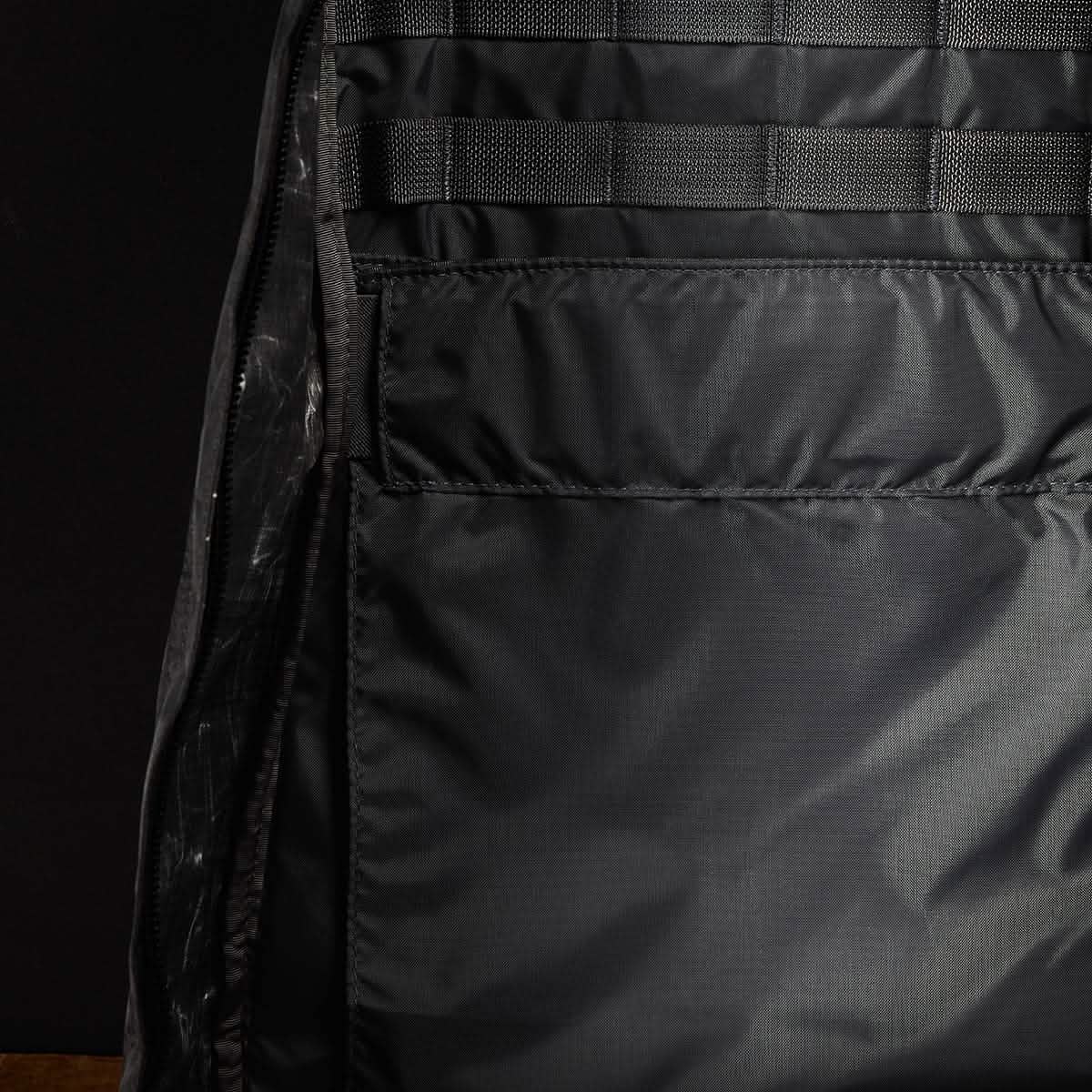 Here's a description based on the product data:

A close-up of the interior of an empty GR1 USA - Dyneema rucksack by GORUCK reveals a spacious main compartment featuring mesh-lined pockets and detailed stitching. The Dyneema® fabric exhibits a subtle sheen, with no visible items inside the backpack.