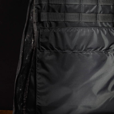 Here's a description based on the product data:

A close-up of the interior of an empty GR1 USA - Dyneema rucksack by GORUCK reveals a spacious main compartment featuring mesh-lined pockets and detailed stitching. The Dyneema® fabric exhibits a subtle sheen, with no visible items inside the backpack.