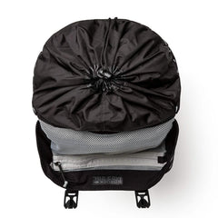 Top view of black GORUCK rucksack with cinch closure and open mesh pocket on white background