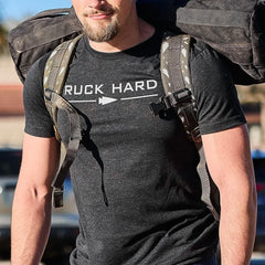 Man wearing black Ruck Hard t-shirt carrying tough rucking backpack with padded straps outdoors