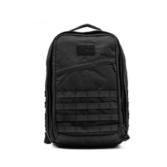 The GR2 by GORUCK is a black tactical backpack designed with Special Forces quality. It includes multiple compartments, a front zipper pocket, horizontal webbing, and a top carry handle. Its rugged design makes it perfect for outdoor adventures and it's also carry-on compliant. The background remains plain white.