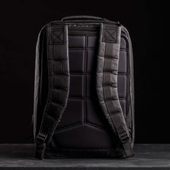 The GR2 USA x Carryology - Ultra Black is a black backpack with padded shoulder straps and back panel, made from durable Challenge Sailcloth, displayed against a dark background.