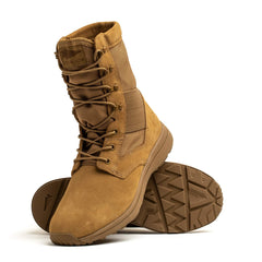 The MACV-1 Hi-Speed - High Top by GORUCK showcases tan military-style features, including high tops, rugged soles, and lace-up fronts. One boot stands upright while the other rests on its side, revealing the tread pattern underneath. Constructed from a combination of suede and nylon, these lightweight rucking boots are perfect for tackling any challenge.