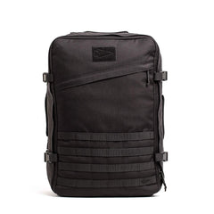 A black rectangular-shaped tactical backpack, the GR3 - Cordura from GORUCK, includes multiple compartments, adjustable side straps, and a small logo patch on the top front. Its water-resistant design features front horizontal webbing for attaching gear or accessories.