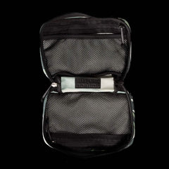 A GR1 Field Pocket x Gear Patrol by GORUCK with a Variegated Elephant Ear Camo pattern features two zippered mesh compartments against a black background. Inside, the center displays a Bear & Path label, reminiscent of the gear recommended for outdoor enthusiasts on Gear Patrol.